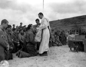 A Roman Catholic priest celebrates Mass during wartime. 