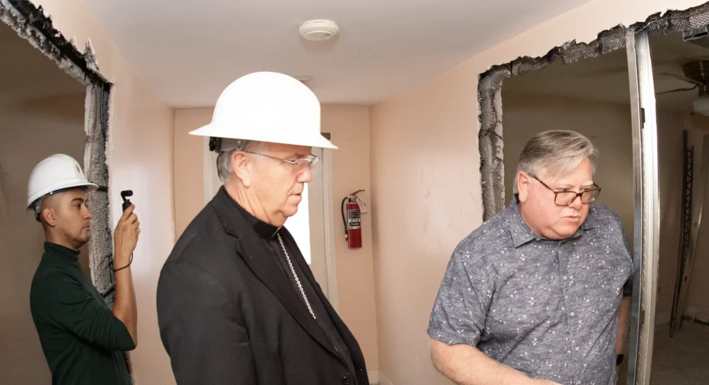 Bishop touring a demolition