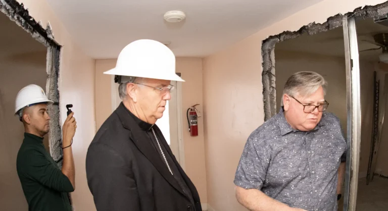 Bishop touring a demolition