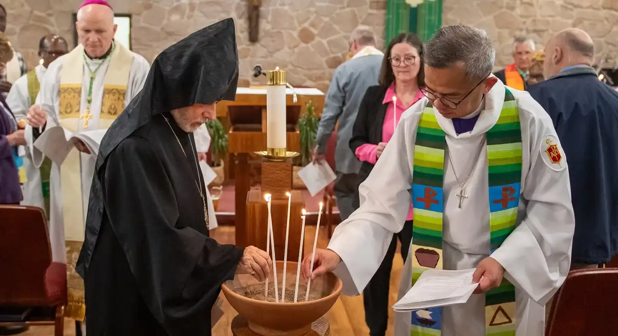 religious leaders holding candles.