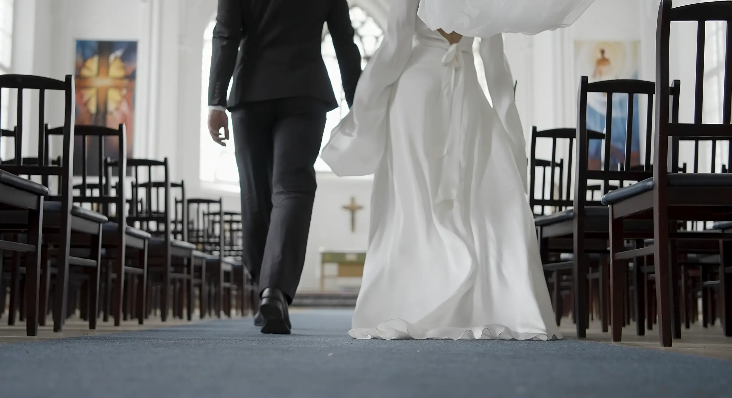 Beautiful newlyweds walking down aisle