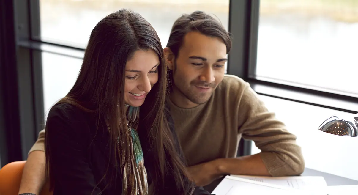 young couple looking over plans