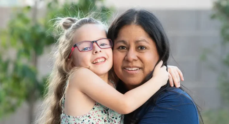 embracing of child and mentor