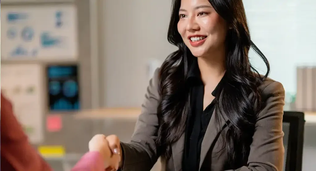 woman shaking hand after interview