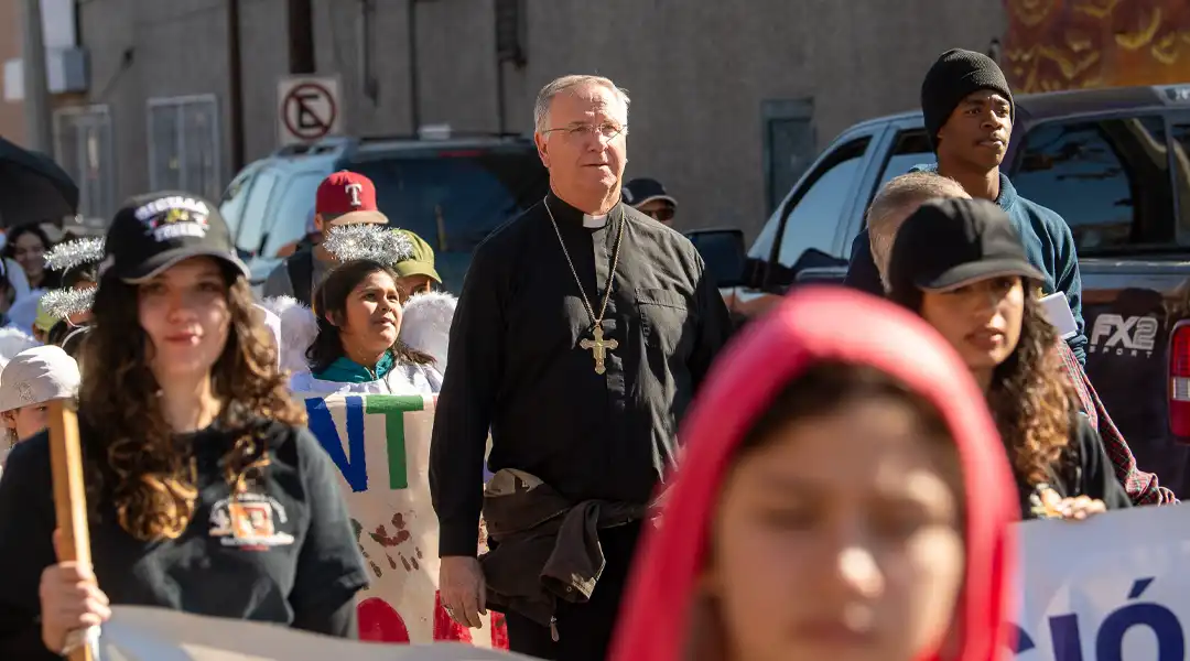 Bishop walking the streets with locals